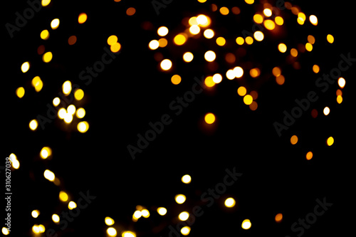 Golden sparkles raster festive background. Bokeh lights with bright shiny effect illustration. Overlapping glowing and twinkling spots decorative backdrop. Abstract glittering circles.