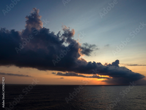 Sunset with dark cloudy sky in the sea