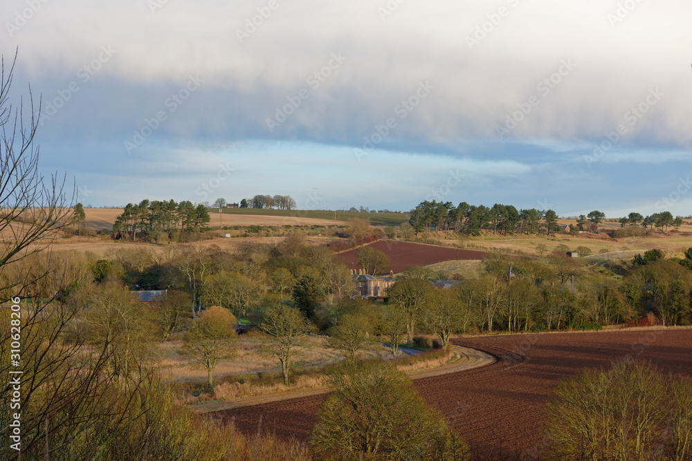 Fototapeta premium The small hamlet of Lunan nestled into the rolling Fields and Countryside of Angus on the East Coast of Scotland.