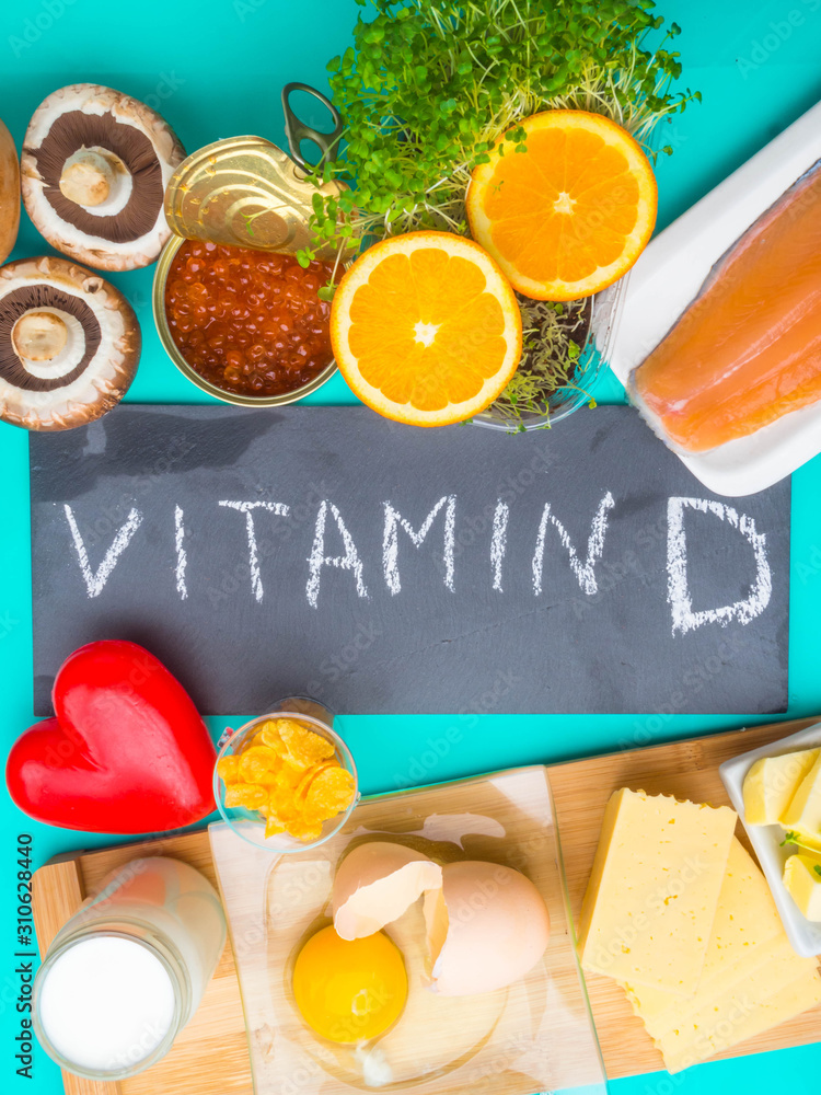 Products containing vitamin D on blue background, top view