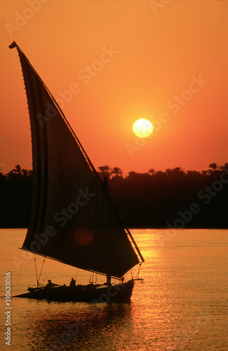 Konstfotografi Felucca sailing at sunset on the river Nile