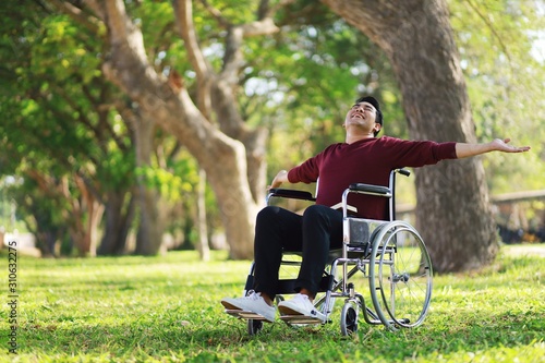 man in wheelchair in park