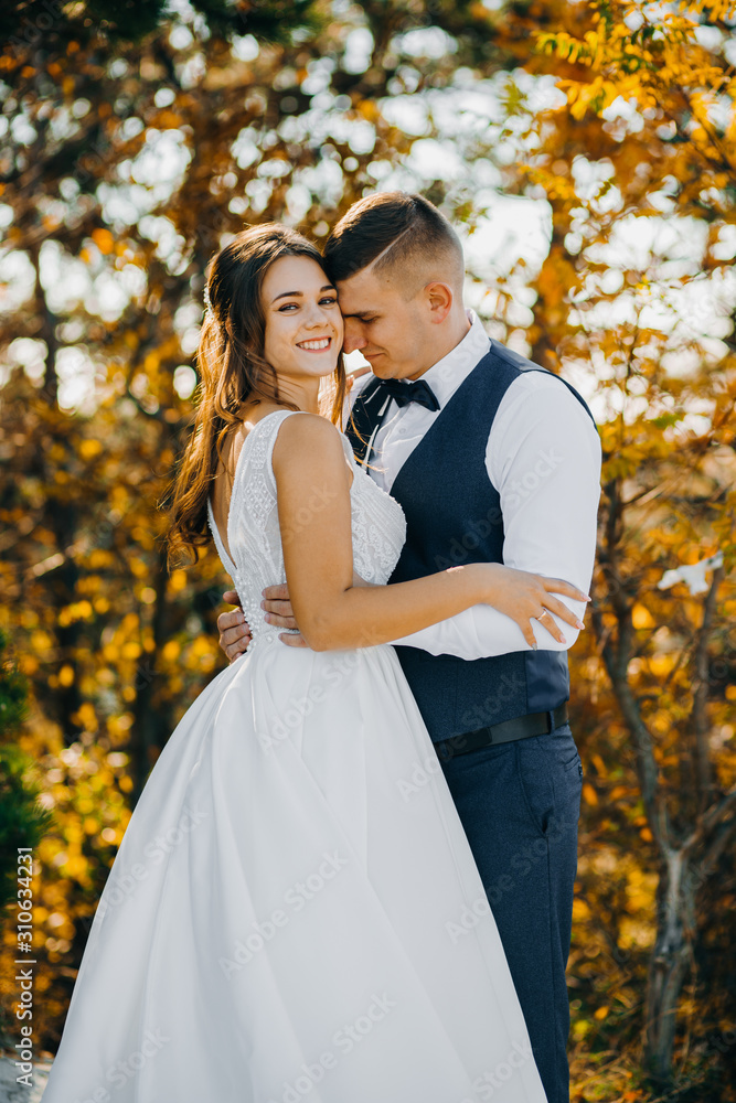 Portrait of beautiful couple in hugs on background of autumn trees Portrait of beautiful couple in hugs on background of autumn trees