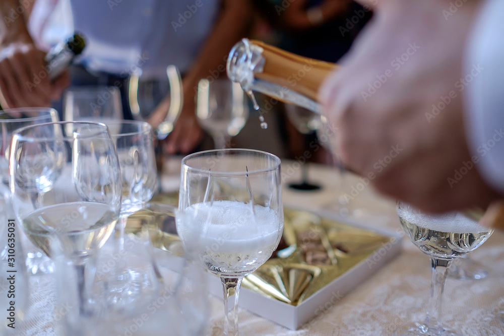 Man pours champagne into glasses 3 Man pours champagne into glasses 3
