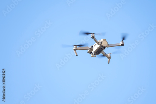 Drone flies in the blue sky 1