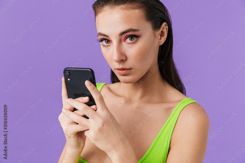 Photo of nice fashion woman using cellphones and looking at camera Photo of nice fashion woman using cellphones and looking at camera