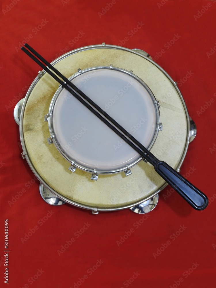 Fototapeta premium Close-up of two Brazilian percussion musical instruments: “tamborim” with drumstick and 