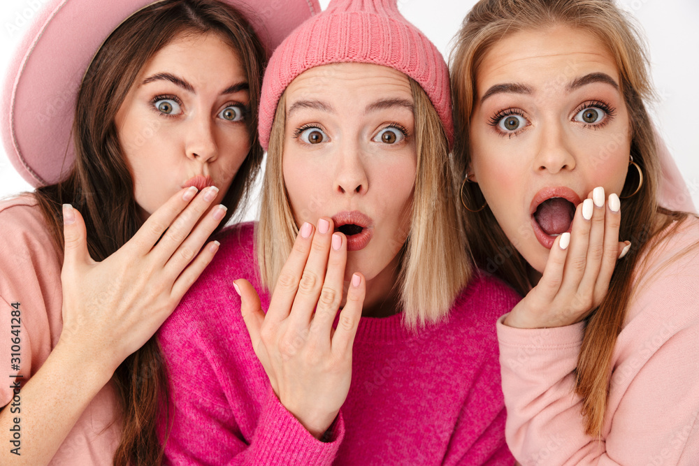 Portrait closeup of three amazed girls wondering and looking at camera Portrait closeup of three amazed girls wondering and looking at camera