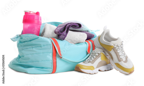 Sports bag with gym equipment on white background