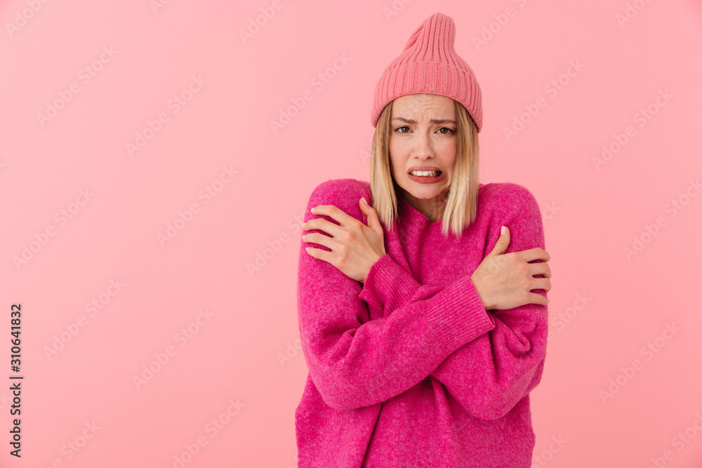 Image of displeased girl wearing hat shaking and trembling from cold