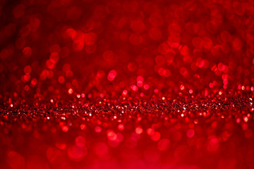 Abstract blur red glitter background card for Valentine's day, christmas and wedding celebration. Love bokeh sparkle confetti textured layout.