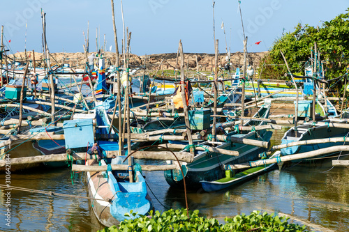Fishing boats stand in Harbour, fish market in Sri Lanka. © vladimircaribb
