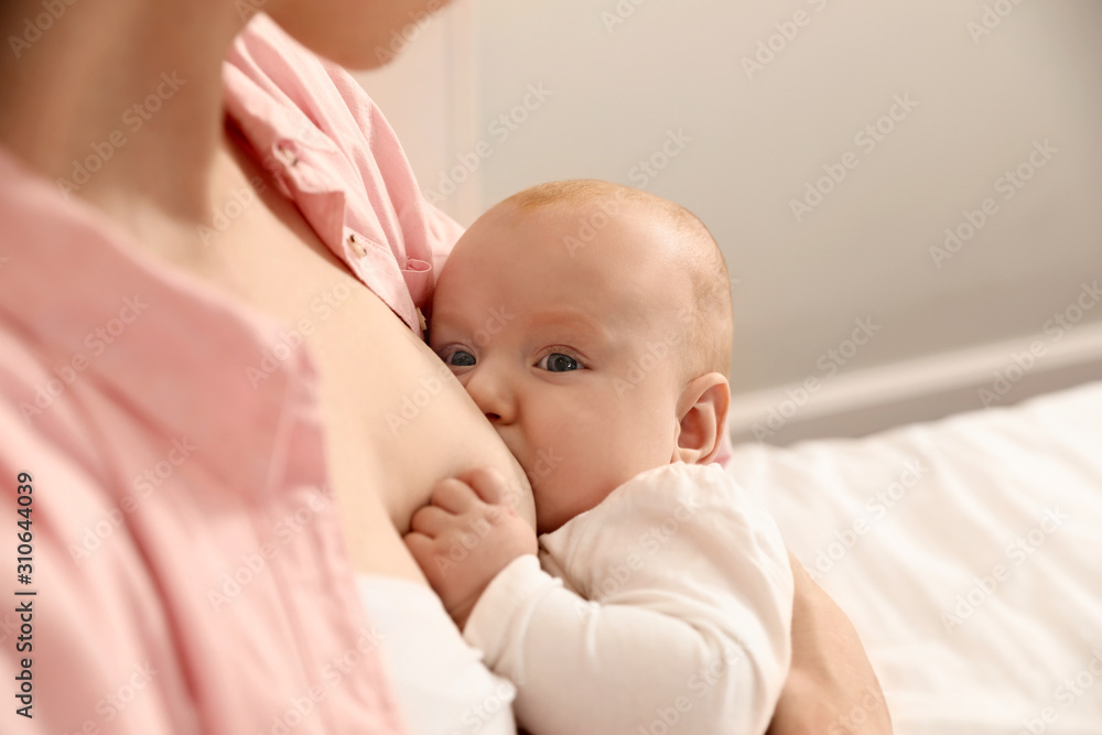 Young woman breast feeding her little baby, closeup Young woman breast feeding her little baby, closeup