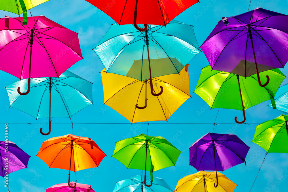 Looking up at the colorful umbrellas. Festive street decoration.