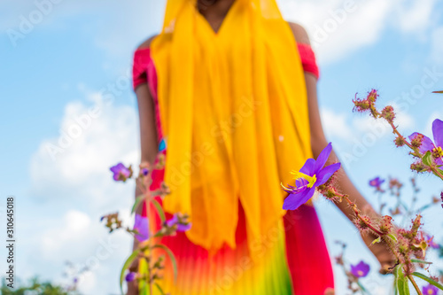 black woman standing in a field of flower
