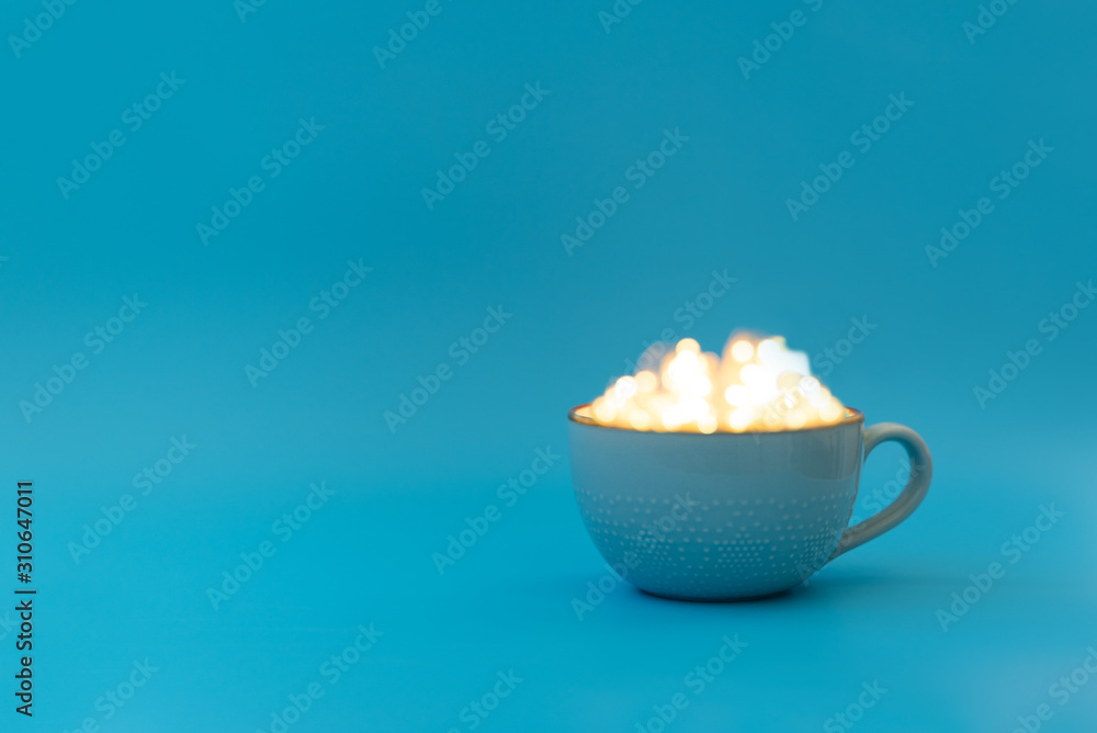 Coffee, hot chocolate or tea mug with magical lights. Morning drink. Christmas or New Year celebration concept. Copy space Coffee, hot chocolate or tea mug with magical lights. Morning drink. Christmas or New Year celebration concept. Copy space