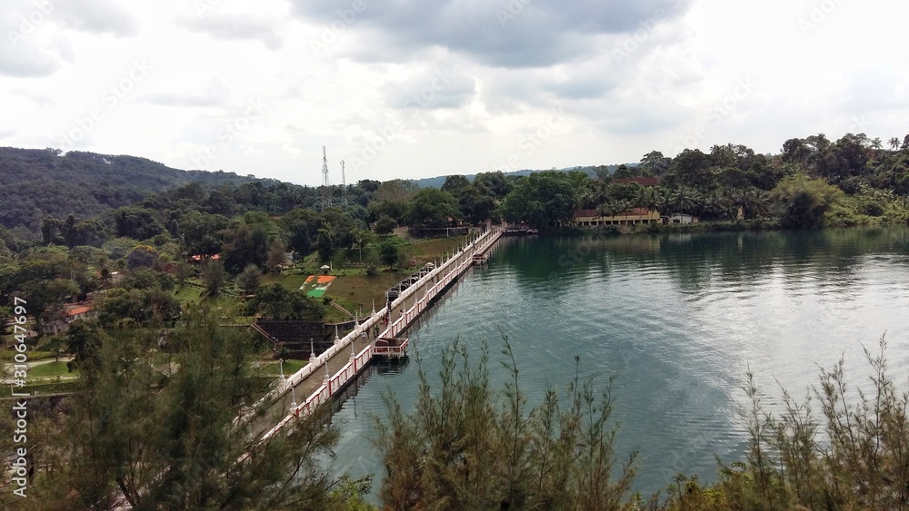 A view of dam filled with greenish appearing water with greenery around. Place : Neyyar Dam, Kerala, India A view of dam filled with greenish appearing water with greenery around. Place : Neyyar Dam, Kerala, India