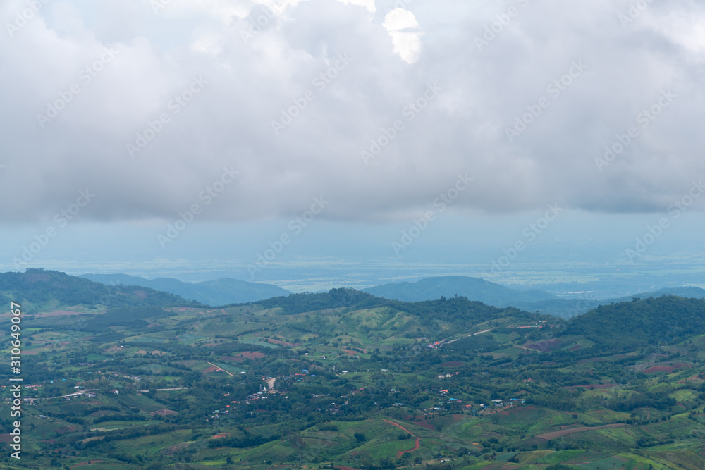 Fototapeta premium beautiful blue sky high peak mountains mist fog wildlife green forest at Khao Koh, Phu Tub Berk, Phetchabun, Thailand guiding idea long weekend for backpacker camping campfire relaxing hiking