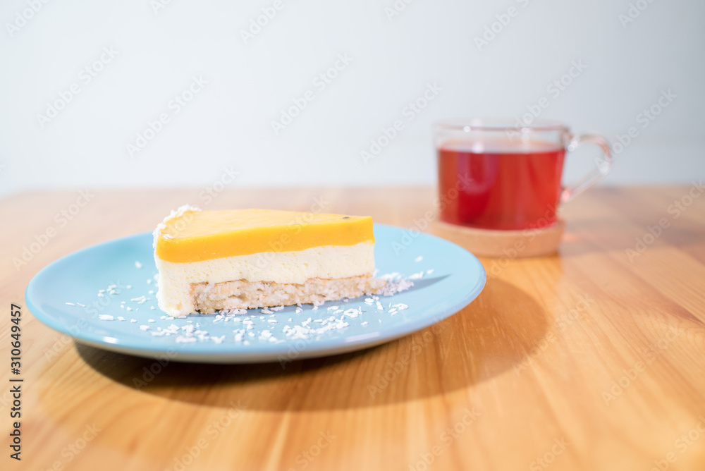 Fototapeta premium Mousse dessert and fruit tea on a large bright wooden table