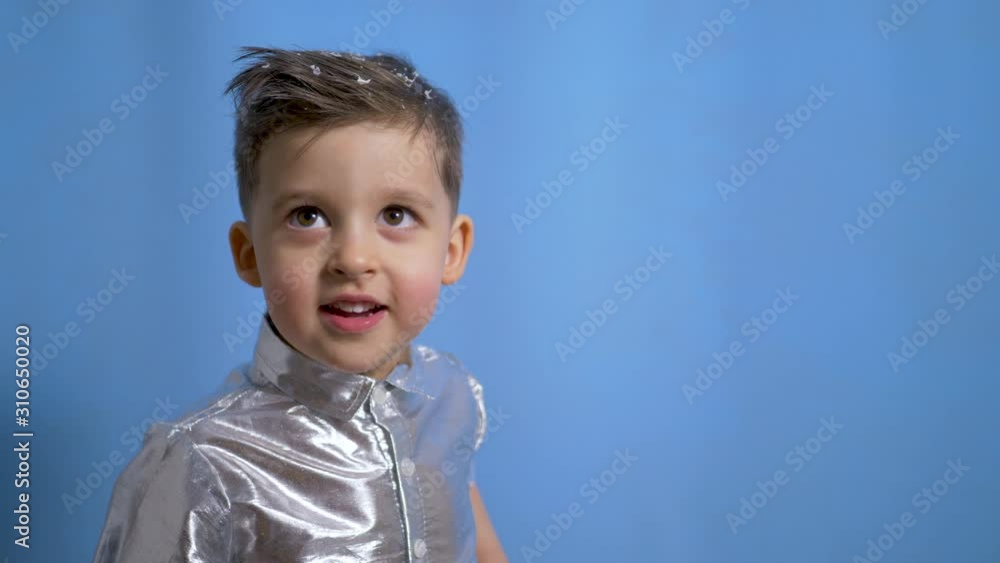 cheerful baby boy in silver holiday shirt in Studio cheerful baby boy in silver holiday shirt in Studio