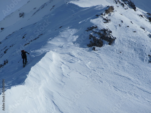 Ski touring, snowboarding and splitboarding in a Beautiful snowy winter mountain landscape in the Swiss alps