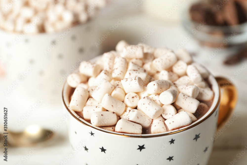 Delicious cocoa drink with marshmallows in cup on table, closeup Delicious cocoa drink with marshmallows in cup on table, closeup