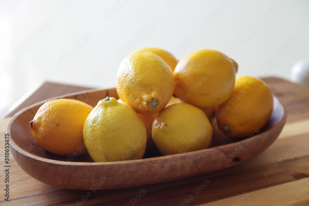 lemons in wood bowl