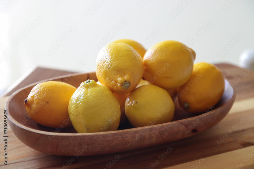 lemons in wood bowl lemons in wood bowl