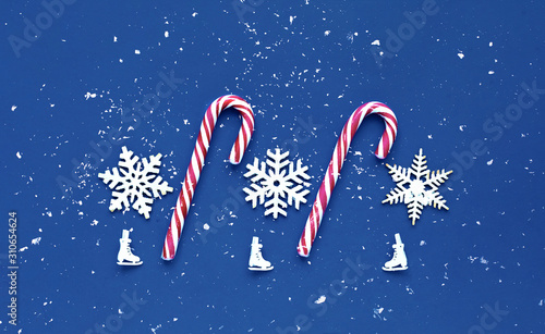 Decorative white christmas decorations on classic blue background. Pattern for holiday paper packaging. Close-up