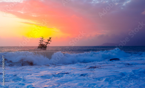 Pirate ship at the sea and a sunset