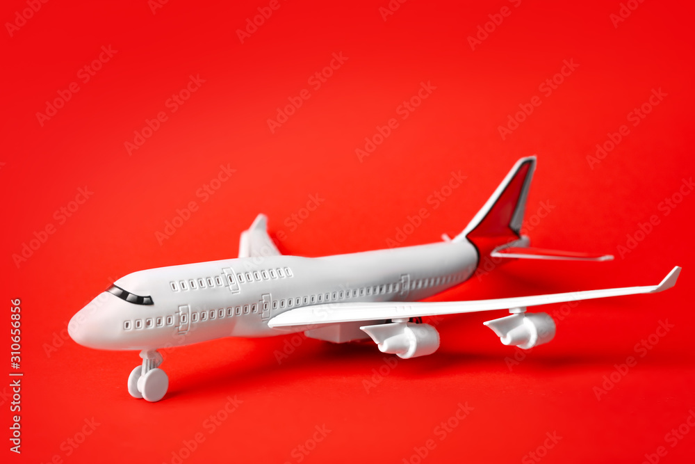 Toy plane on red background. Logistics and wholesale concept Toy plane on red background. Logistics and wholesale concept