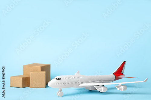Toy plane on blue  background, space for text. Logistics and wholesale concept