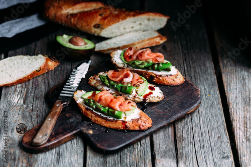Sandwich with cream cheese, avocado, asparagus and salted salmon