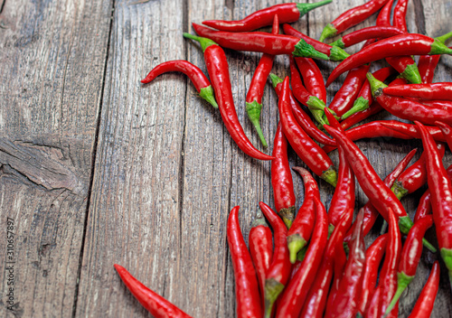 Red hot peppers on wooden background