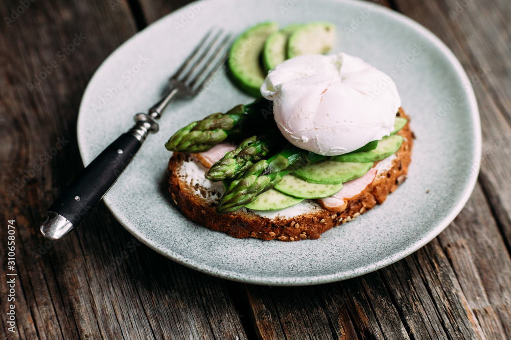 Sandwich with cream cheese, avocado, asparagus and poached egg Sandwich with cream cheese, avocado, asparagus and poached egg