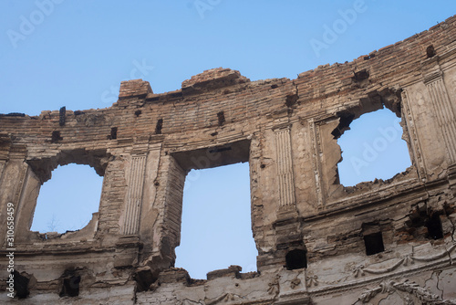 Landscape of ruined buildings on the blue sky background , image of decrepitude or natural time disaster. The detail of old house sight