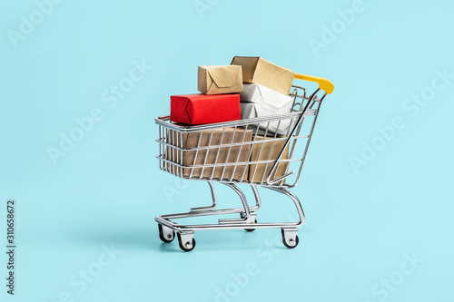 Shopping cart and box on blue background, business , shopping concept