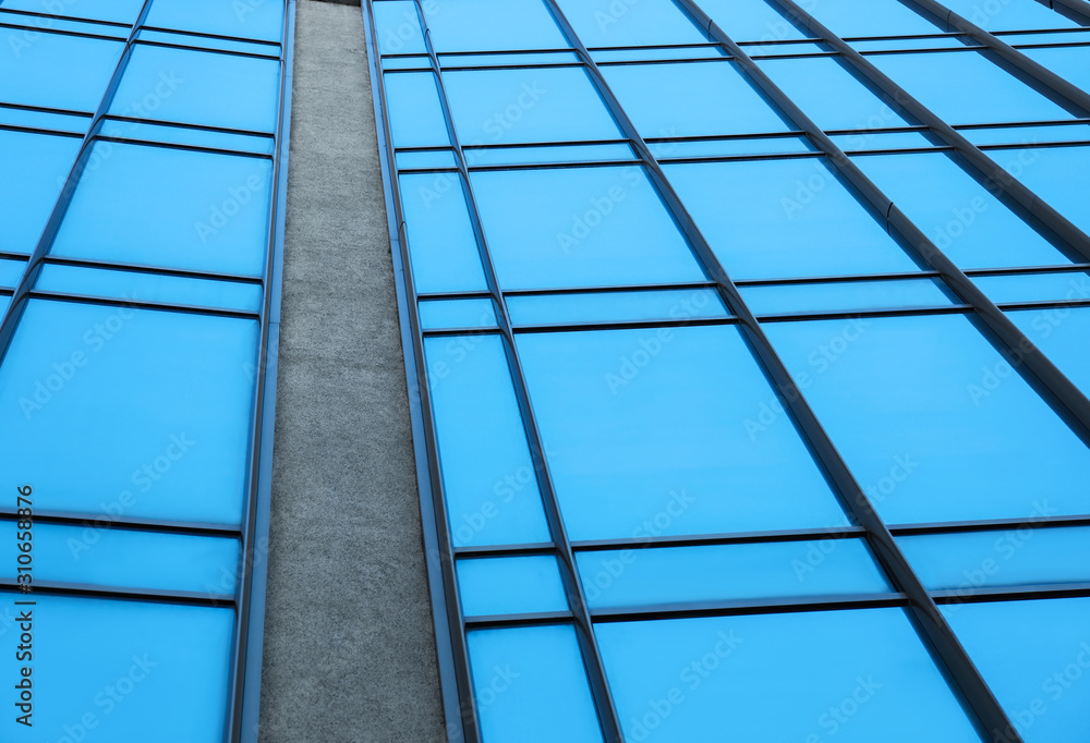 Modern building with tinted windows, low angle view Modern building with tinted windows, low angle view