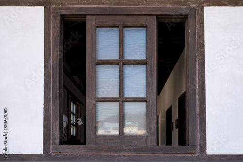 Brown wooden window opened on wall