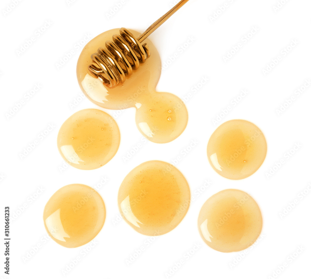 Drops of honey and dipper on white background, top view Drops of honey and dipper on white background, top view