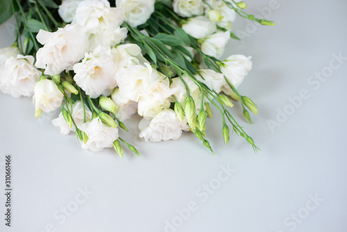 Beautiful bouquet of white flowers on a grey background. Free space for text. A romantic date, a gift. Bouquet for the tender bride girl, witnesses. Declaration of love. White fresh branch close up