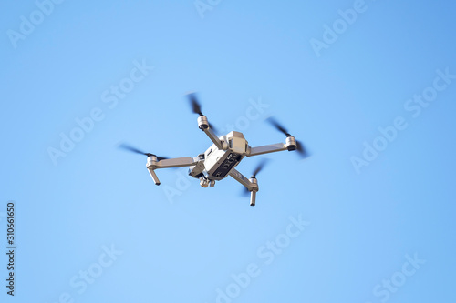 Drone flies in the blue sky 2