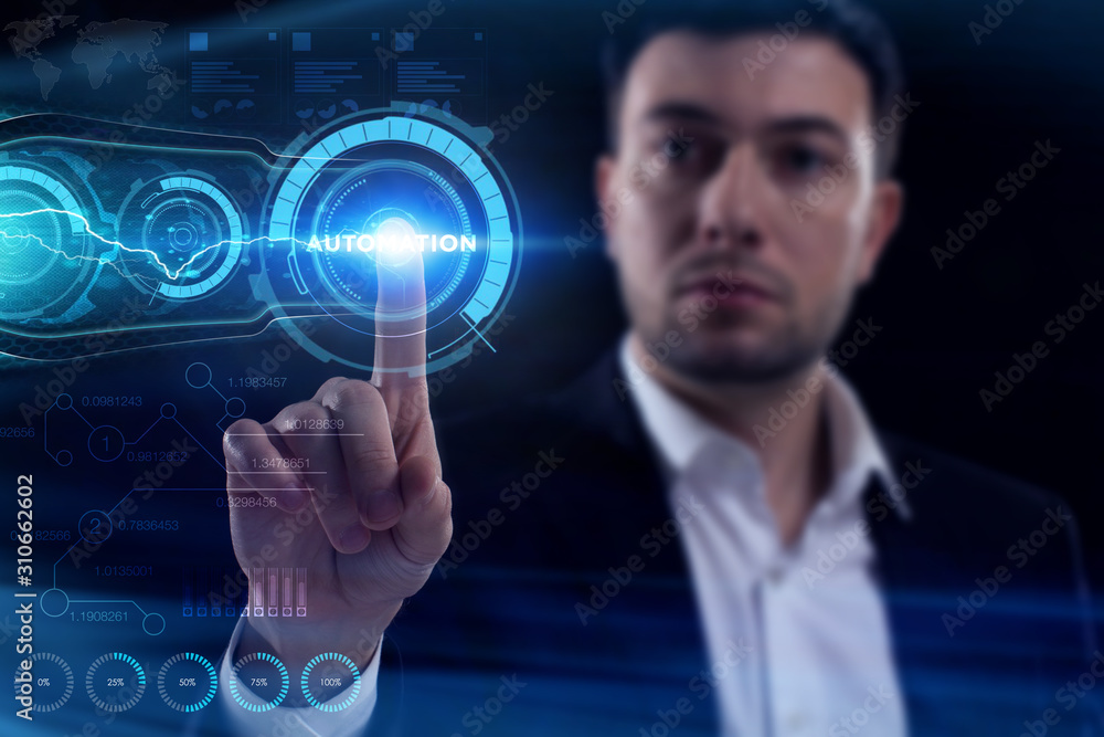 Business, Technology, Internet and network concept. Young businessman working on a virtual screen of the future and sees the inscription: Automation Business, Technology, Internet and network concept. Young businessman working on a virtual screen of the future and sees the inscription: Automation