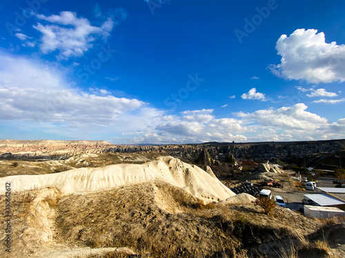 View of a valley filled with ancient rock formations. Blue sky, white clouds. Landscape. Cappadocia, Turkey. 5 november 2019