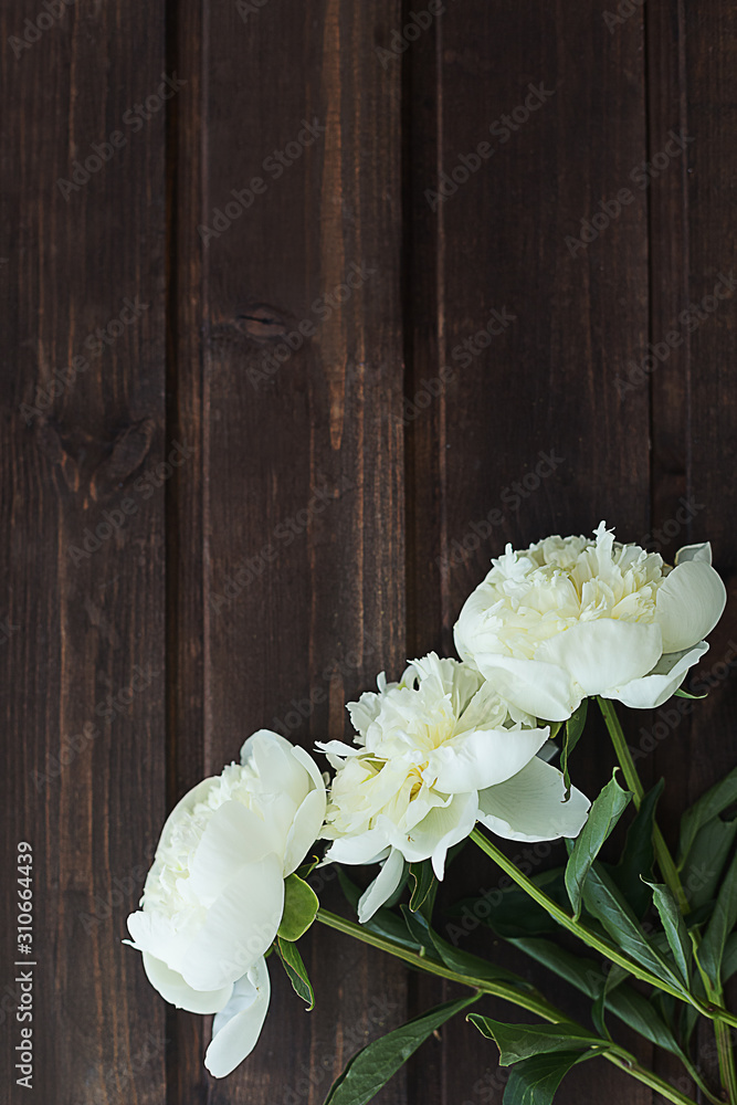 Flower composition. White peonies on a vertical wooden background. Flower composition. White peonies on a vertical wooden background.