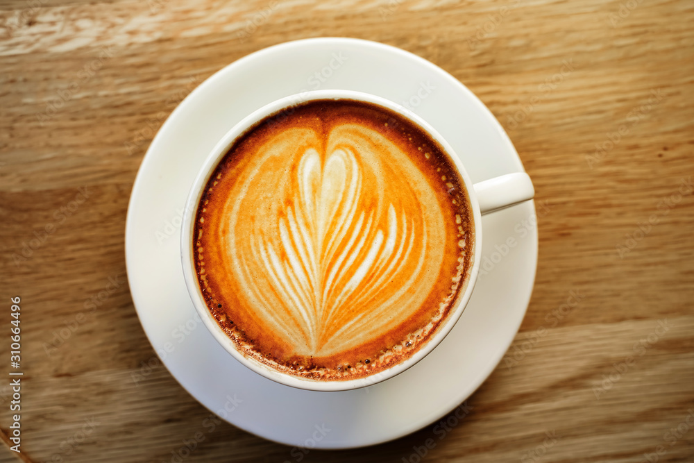 cup of the latte art coffee with warm light cup of the latte art coffee with warm light