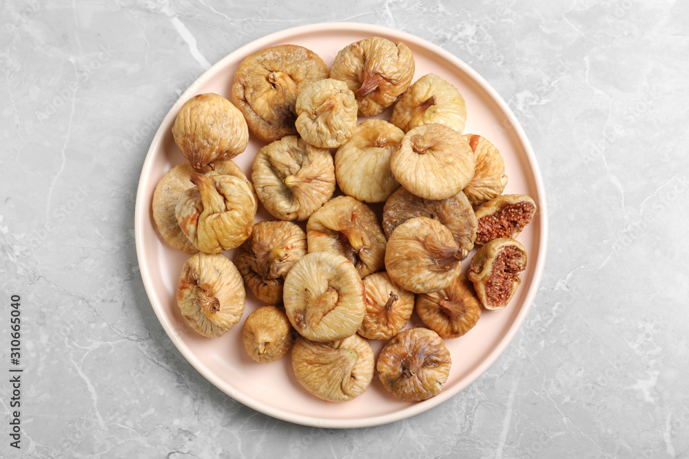 Tasty dried figs on light grey marble table, top view Tasty dried figs on light grey marble table, top view