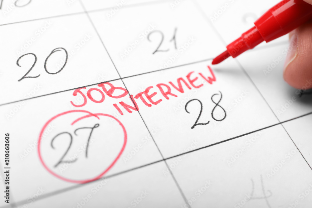 Woman marking date of job interview in calendar, closeup Woman marking date of job interview in calendar, closeup