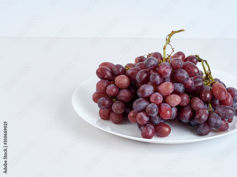 Bunch of grapes on white plate. Bunch of grapes on white plate.