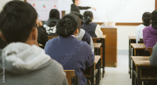 High school or college students studying . Back to school. Group of asian children reading a book and writing a notebook together with fun and happiness